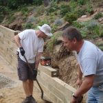 Tim Kent landscaping workers building a retaining wall