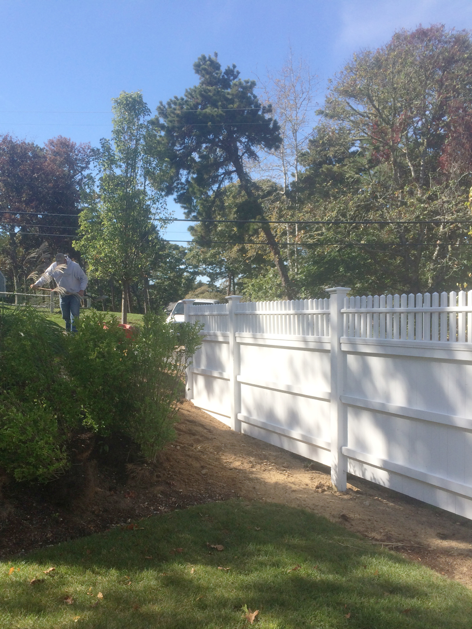 Attractive white fence with work finishing up